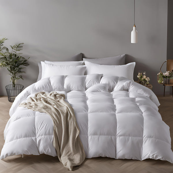 A white duck feather & down  duvet displayed on a bed, with a cozy and inviting appearance, in a room with minimalistic decor.