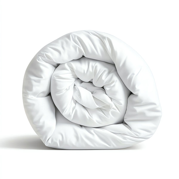 A rolled-up white microfibre all season duvet on a white background.